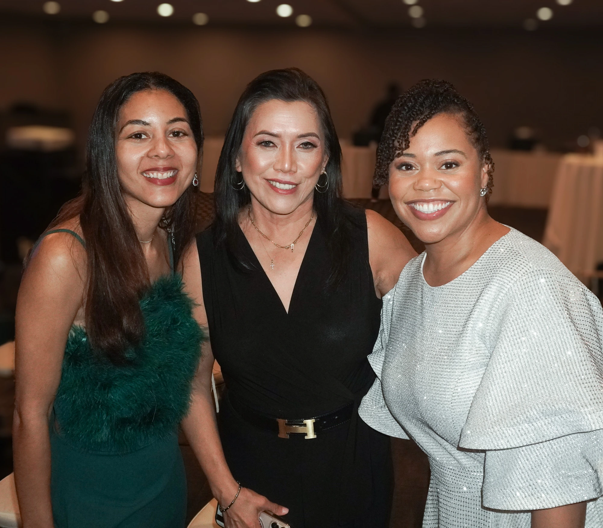 Three guests in emerald, black, and silver sparkle