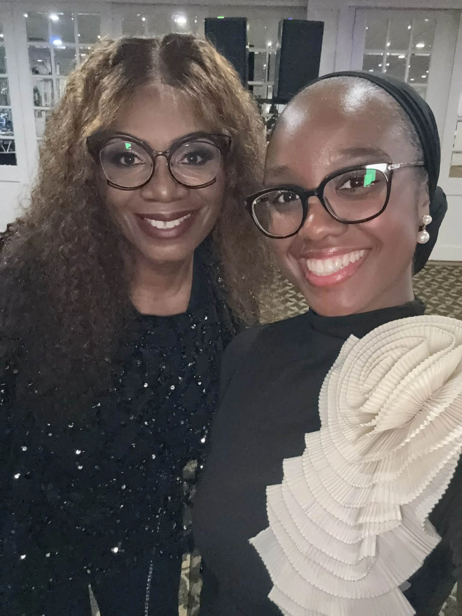 Two guests sharing a joyful selfie